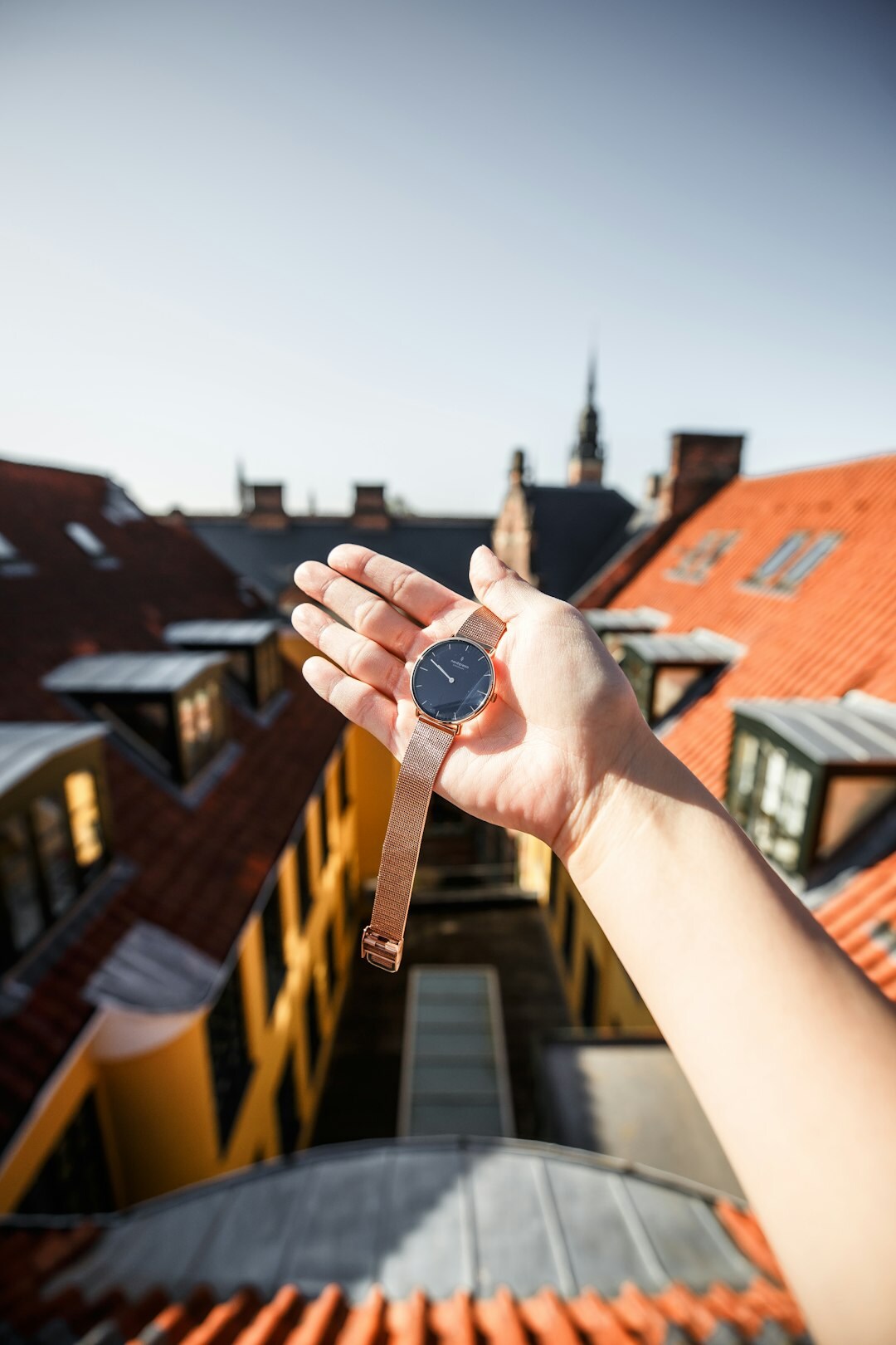 Hand holding a compass over a map of Denmark